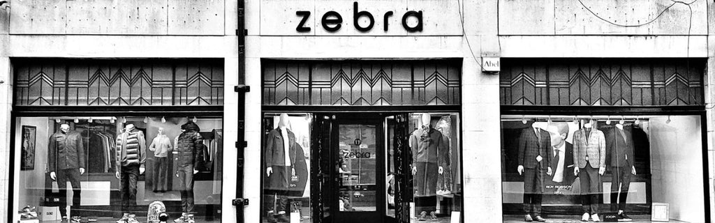 Zebra Chesterfields Premier Menswear Store Est. 1986 Banner Blurred Background